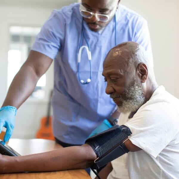 A medical professional works with a patient